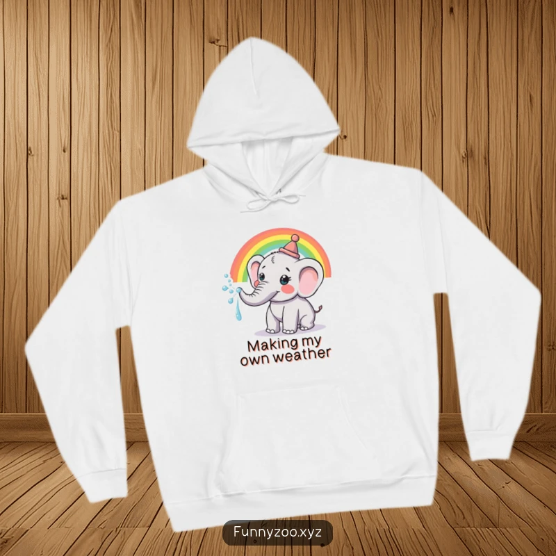 Funny Hoodie: Soft fleece featuring a cheerful elephant in a tiny hat, spraying a beautiful rainbow from its trunk.